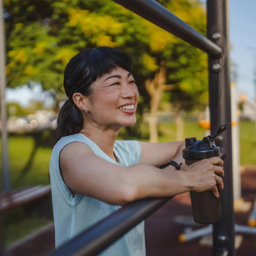 Woman exercising on outdoor fitness equipment in a park